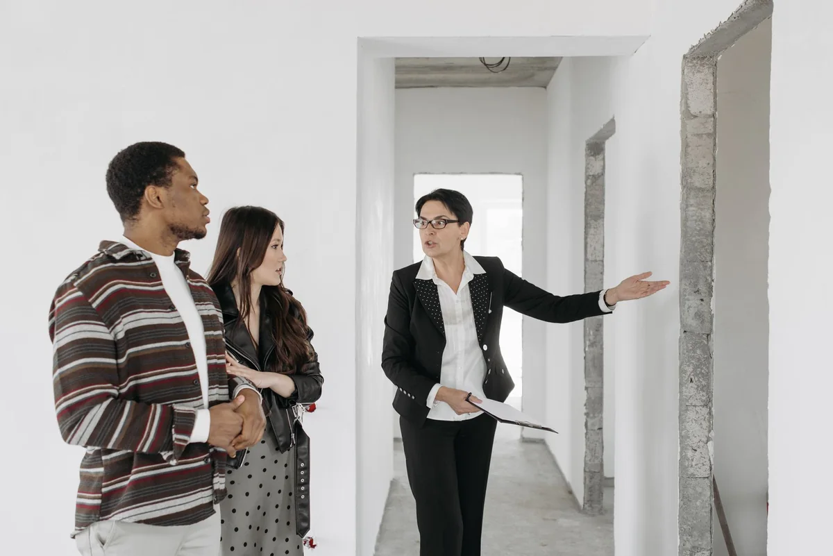 Real estate agent showing a home to a couple in Iowa