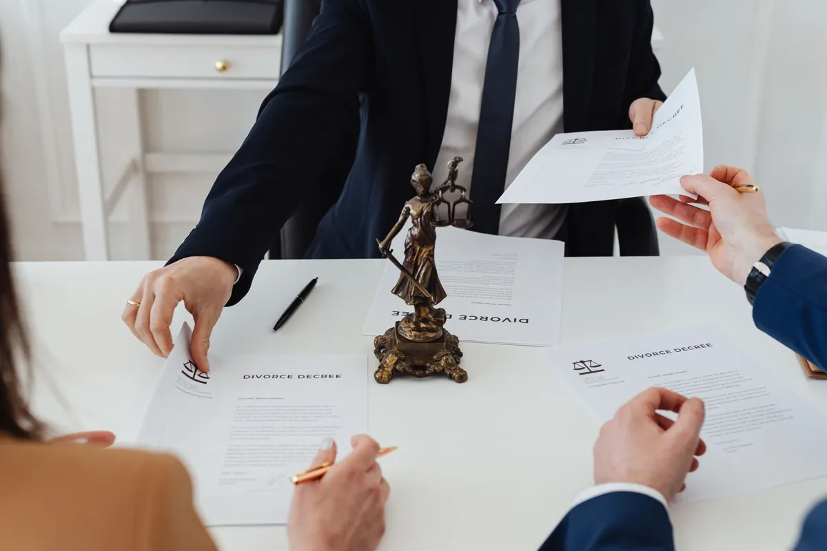 Estate and trust paperwork changing hands across a desk