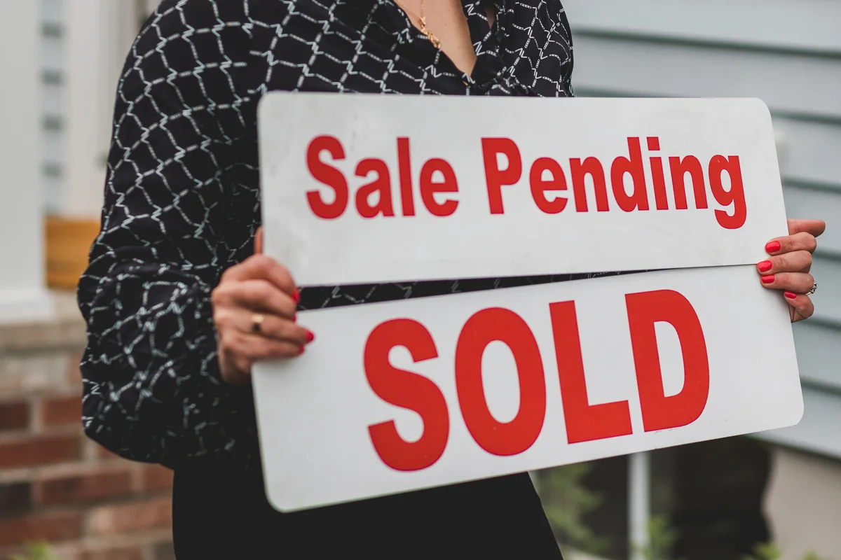 For sale sign outside an Iowa house inherited by multiple siblings