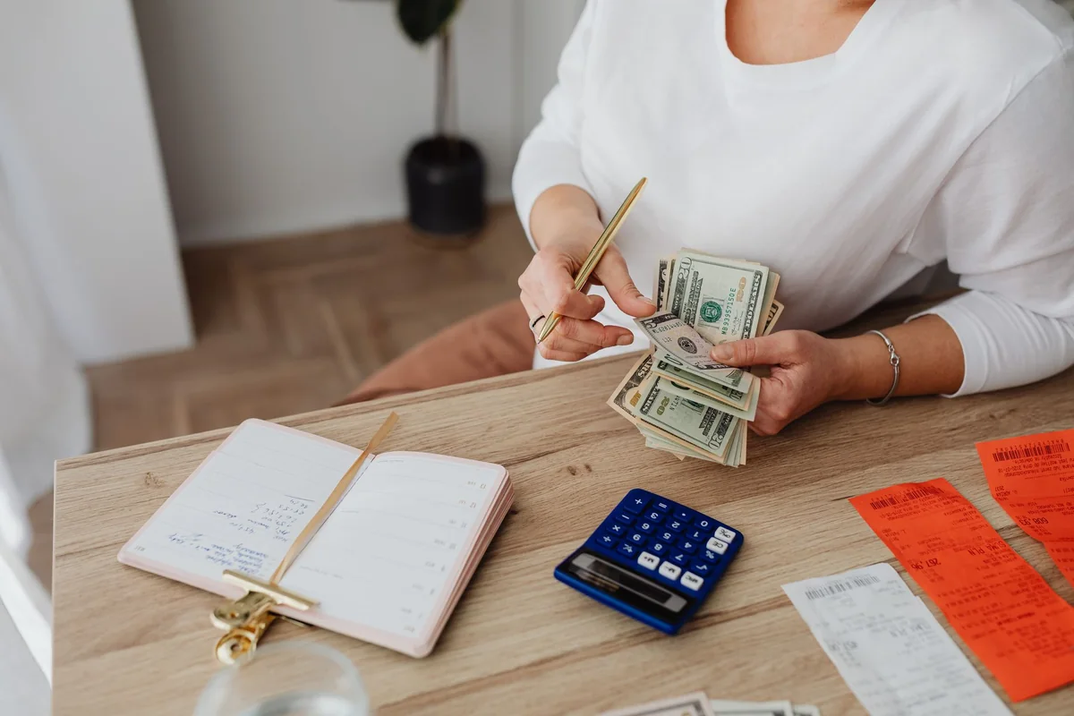 A homeowner counting out cash to make a mortgage payment before closing