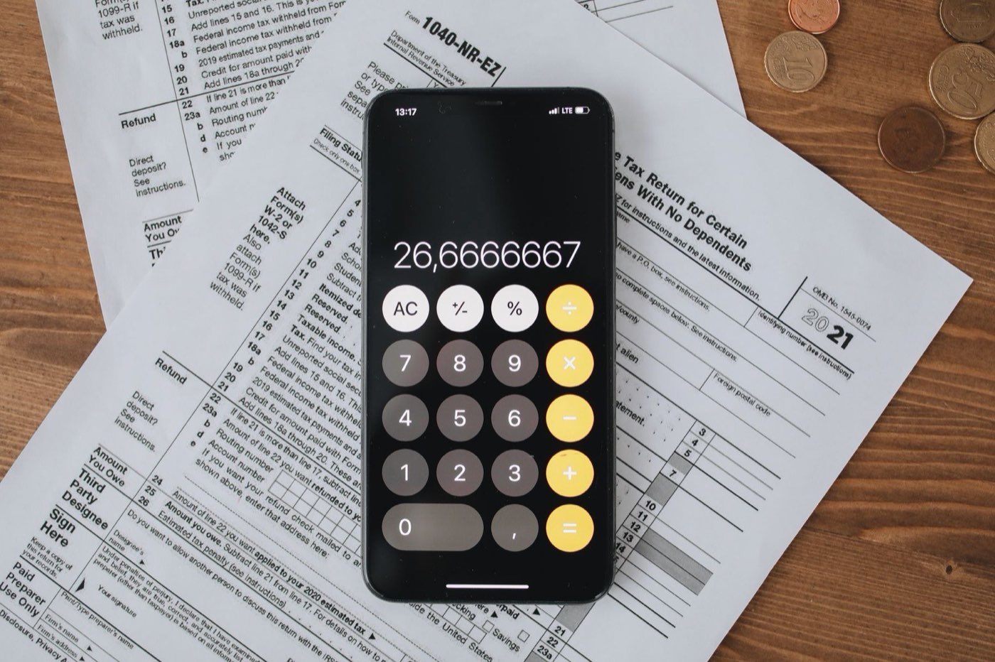 Tax documents and a calculator on a desk for figuring taxes on selling a house in Iowa