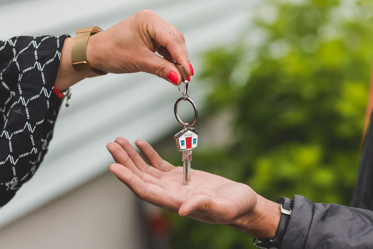 A single house key, symbolizing handing over ownership of a home without selling it