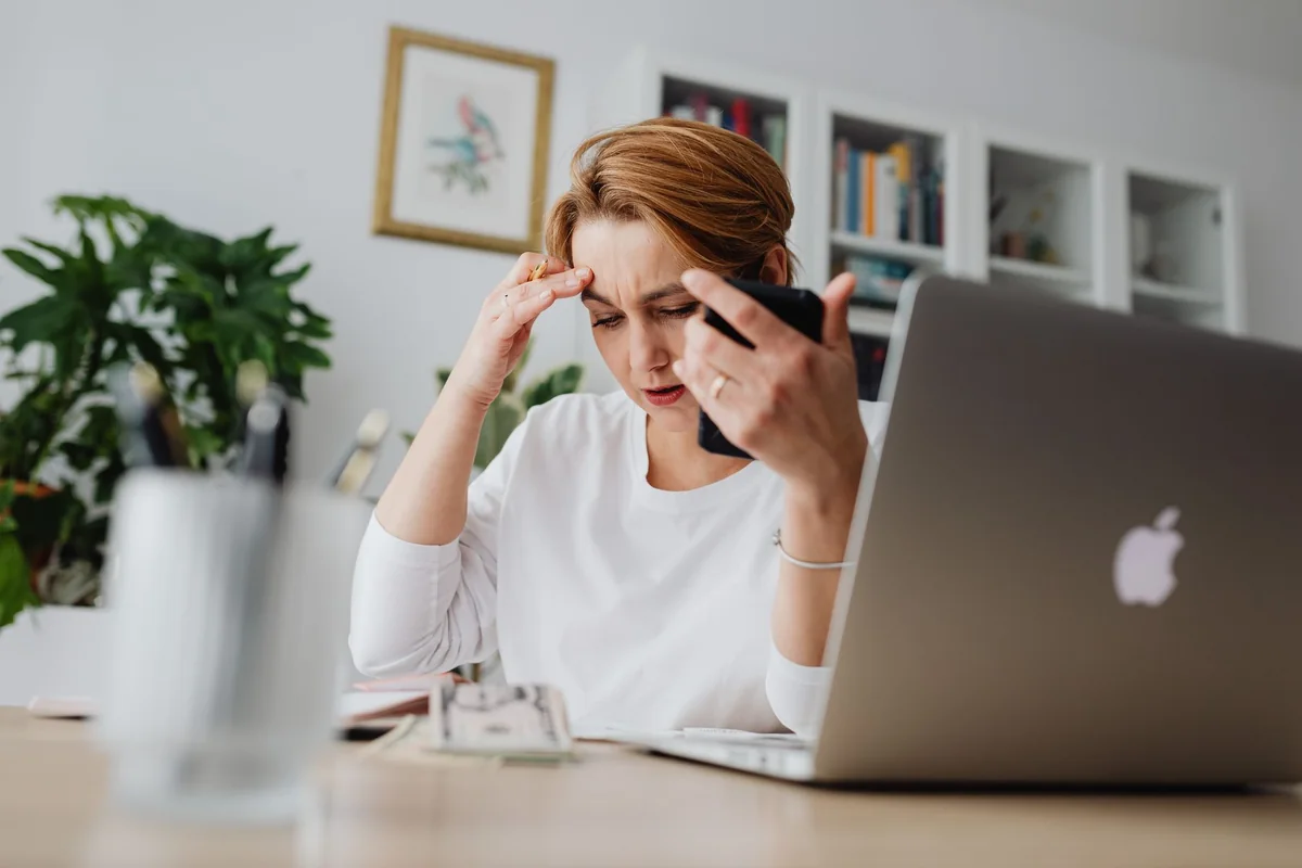 A homeowner at a desk studying a we buy houses letter, weighing the cash home buyer red flags before responding in Iowa